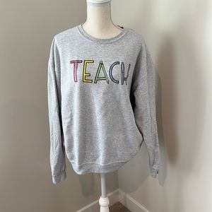 Gray Crew Neck Sweater with Colorful 'Teach' Design
